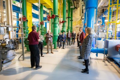 Several people listen to a tour leader give details on the building they're touring. 