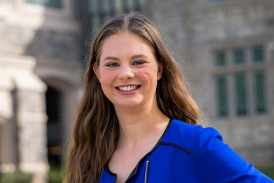 Portrait of Katie Drinkwater outside wearing a blazer.